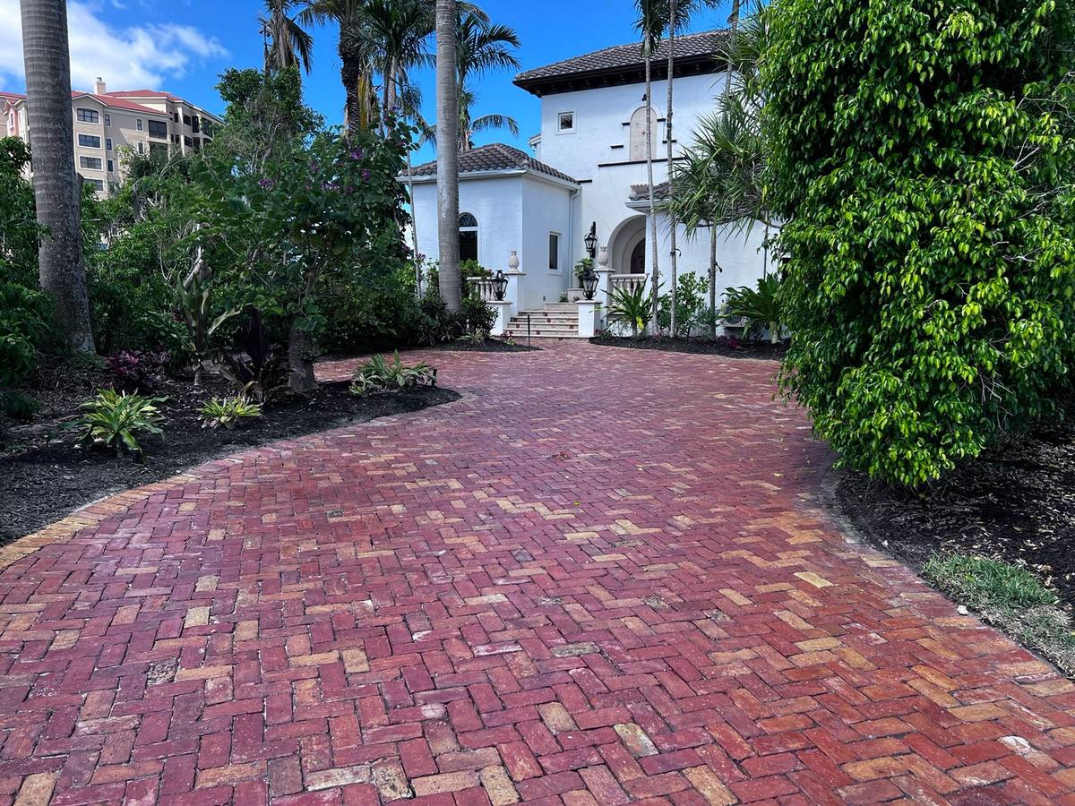Restored Chicago brick driveway curving up to a Fort Myers home