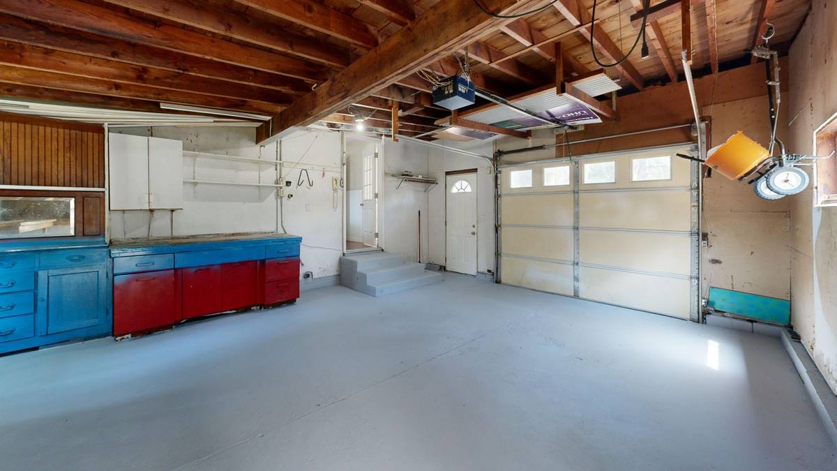 Clean garage with a smooth grey coated concrete floor and storage cabinets