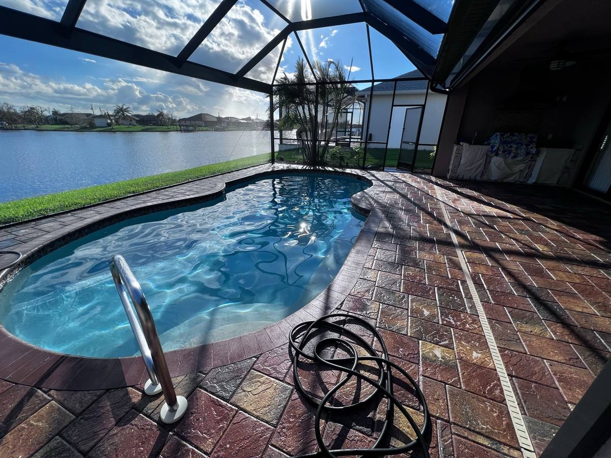 Sealed paver lanai and pool deck overlooking a lake