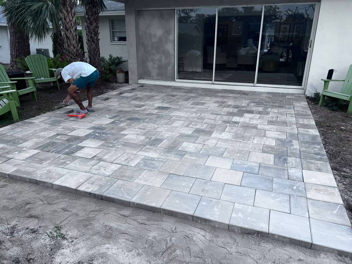 Newly installed grey and white paver patio behind a Southwest Florida home