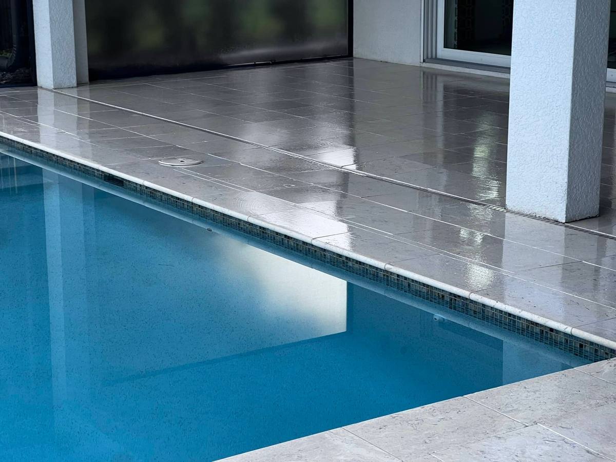 Stone pool deck cleaned & sealed: travertine & natural stone care by Paver Savers & Concrete